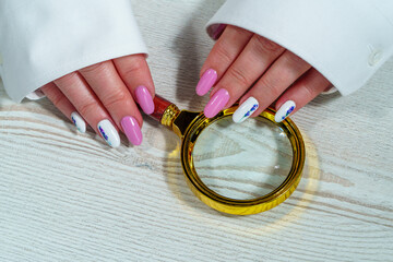 A woman's hand with a manicure using nail polish. Manicure using nail polish.