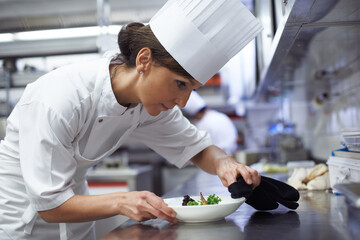 Woman, chef and food in fine dining restaurant for cooking, hospitality and meal in kitchen. Female...