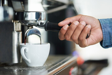 Espresso, barista and coffee machine in cafe for morning, beverage and hot liquid for brewing....