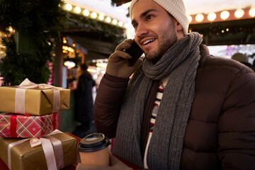 Man calling via phone on Christmas Market