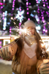 Caucasian woman with sparklers during New Years's party outdoors
