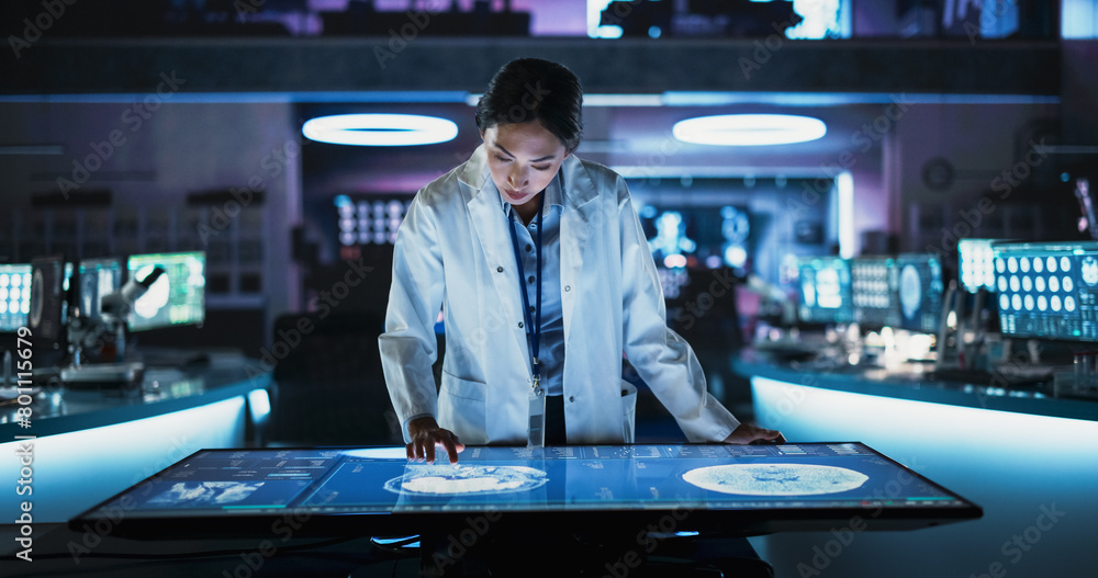 Aufkleber Female Asian Neuroscinetist Using Interactive Touch Screen Table With MRI Scans On Display In Modern Biotechnology Research Center. Doctor Developing Innovative Devices For People With Alzheimer's.