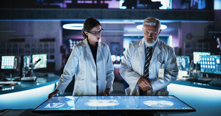 Modern Hospital Medical Research Center: Caucasian Female Neuroscientist And Male Surgeon Talking,...