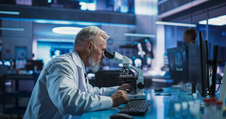 Medical Development Laboratory: Caucasian Male Scientist Using Microscope, Analyzes Petri Dish...