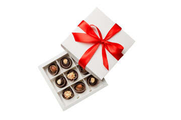 Chocolate candy in a box with a colored bow. Gift box with Chocolates isolated on white top view - obrazy, fototapety, plakaty