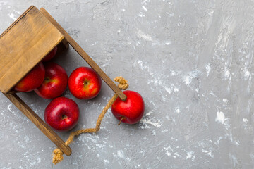 Many red apples on cement background, top view. Autumn pattern with fresh apple above view