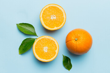 Fruit pattern of fresh orange slices on colored background. Top view. Copy Space. creative summer concept. Half of citrus in minimal flat lay