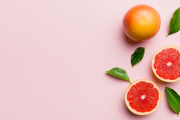 fresh Fruit grapefruit with Juicy grapefruit slices on colored background. Top view. Copy Space. creative summer concept. Half of citrus in minimal flat lay with copy space