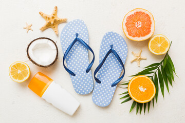 Top view composition of flip flops placed with beach accessories top view on table background....