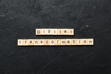 digital transformation word written on wood block. digital transformation text on cement table for...