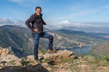 Man Posing with Mountainous Backdrop