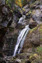 Waterfall of the strait (Estrecho waterfall) in autumn in the Ordesa Valley National Park in Aragon Pyrenees. Huesca, Spain. Ara river waterfalls.