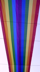 Large rainbow banner seen from below. Pride month concept