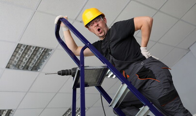 Adult caucasian handyman hold hand on lower back portrait. Occupational Safety and Health concept