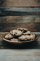  A bowl of cookies in a wooden bow.l  
