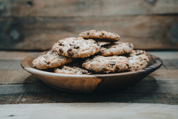  A bowl of cookies in a wooden bow.l  
