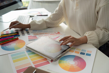 Graphic or UI designer work on computer laptop and with tablet after brainstorming unique design with professional developer UX team