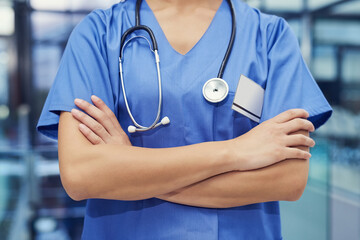 Doctor, hands and arms crossed or professional healthcare in hospital or confidence for...