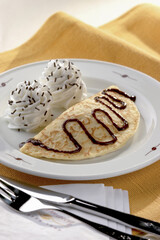 chocolate pancake with chocolate syrup and cream