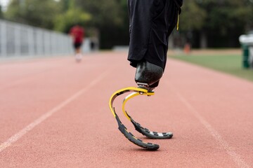 Athlete with prosthetic legs on a running track