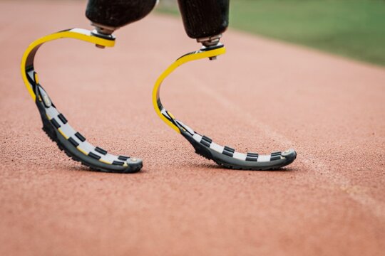 Athlete with prosthetic legs on a running track