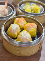 Shrimp shumai is a type of traditional Chinese dumpling. Chinese steamed dumpling in bamboo steamer.