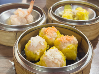 Shrimp shumai is a type of traditional Chinese dumpling. Chinese steamed dumpling in bamboo steamer.