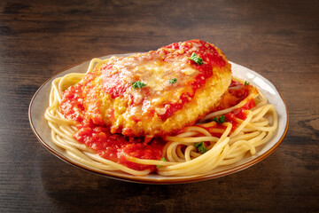 Chicken Parmesan, Italian pasta dish. Breaded chicken breast with cheese and spaghetti with tomato...