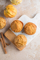 Autumn pumpkin cupcakes or  baked muffins with fresh pumpkin for Thanksgiving day.