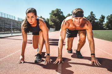 Man and woman athletes racing against each other