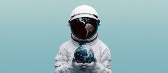 Astronaut in spacesuit and helmet holding planet Earth. Concept of conservation of planet earth.