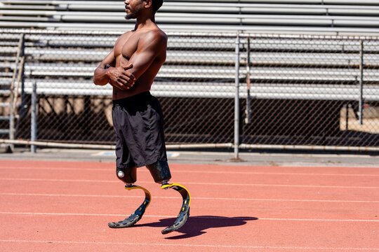 Man paralympic athlete running with prosthetic legs