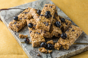 Various granola bars on table background. Cereal granola bars. Superfood breakfast bars with oats,...