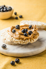 Peanut butter and rice cakes sandwich. Healthy protein snack.