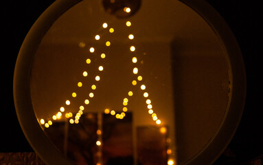 The glow of lightening reflects in a circular mirror. Cozy Atmosphere: Lantern Reflection in...