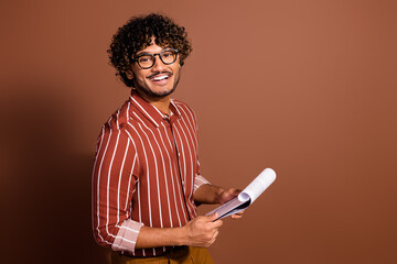 Profile portrait of nice young man clipboard empty space wear striped shirt isolated on brown color...