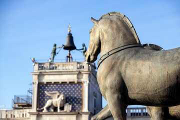 View of Horses of Saint Mark and the winged lion at the Clock Tower defocused in the background on...