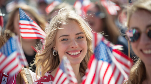 Young woman smiling, holding American flags at outdoor event.