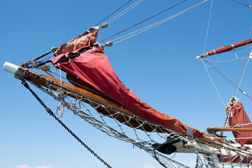 Ship's bow with jib boom and knotted jib net in front of the foremast of a moored sailing ship,...