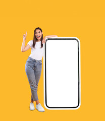 Woman showing white empty smartphone screen and pointing up