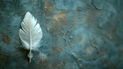  A white feather atop a blue and rusted metal surface against a backdrop of weathered rust