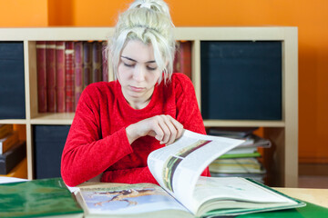 Concentrated student reading books in library