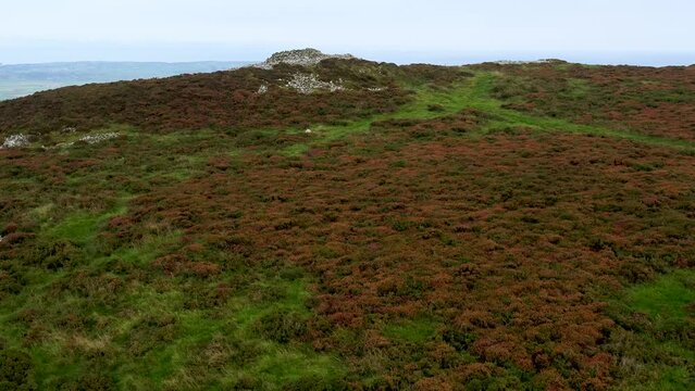 Prehistoric late Neolithic or Bronze Age long cairns on summit of Mynydd Rhiw on Llyn Peninsula, north Wales. Cairns 2 and 1 looking S.E. Video fly up