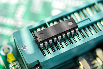DIP microcontroller in the ZIF socket of programming adapter. Electronic software engineering.
