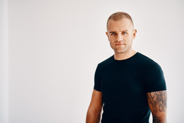 Handsome young man looking to camera over soft white background