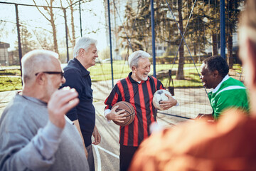 Group of senior men enjoying a conversation and sports in a park