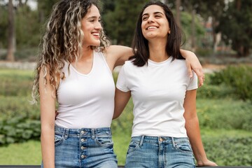 Obraz premium Women in casual wear apparel, talking in a park