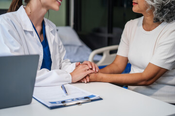 Monthly health check-ups and counseling sessions are provided to an elderly Asian woman by a Caucasian female caregiver, offering support, advice, and motivation.