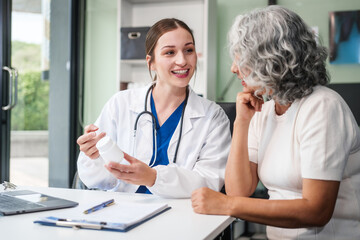 Monthly health check-ups and counseling sessions are provided to an elderly Asian woman by a...