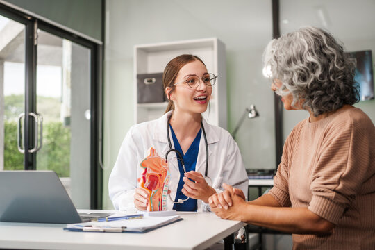 Caucasian woman and elderly Asian woman discuss health issues cold, influenza, pneumonia, bronchitis, stomach disease, GERD, IBS, inflammatory bowel disease, gallstones, chronic constipation